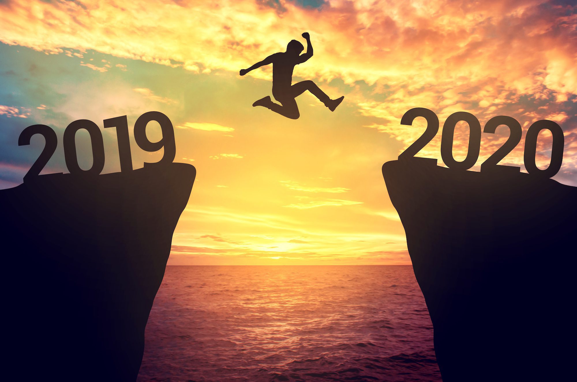 Businessman jump between 2019 and 2020 years.
